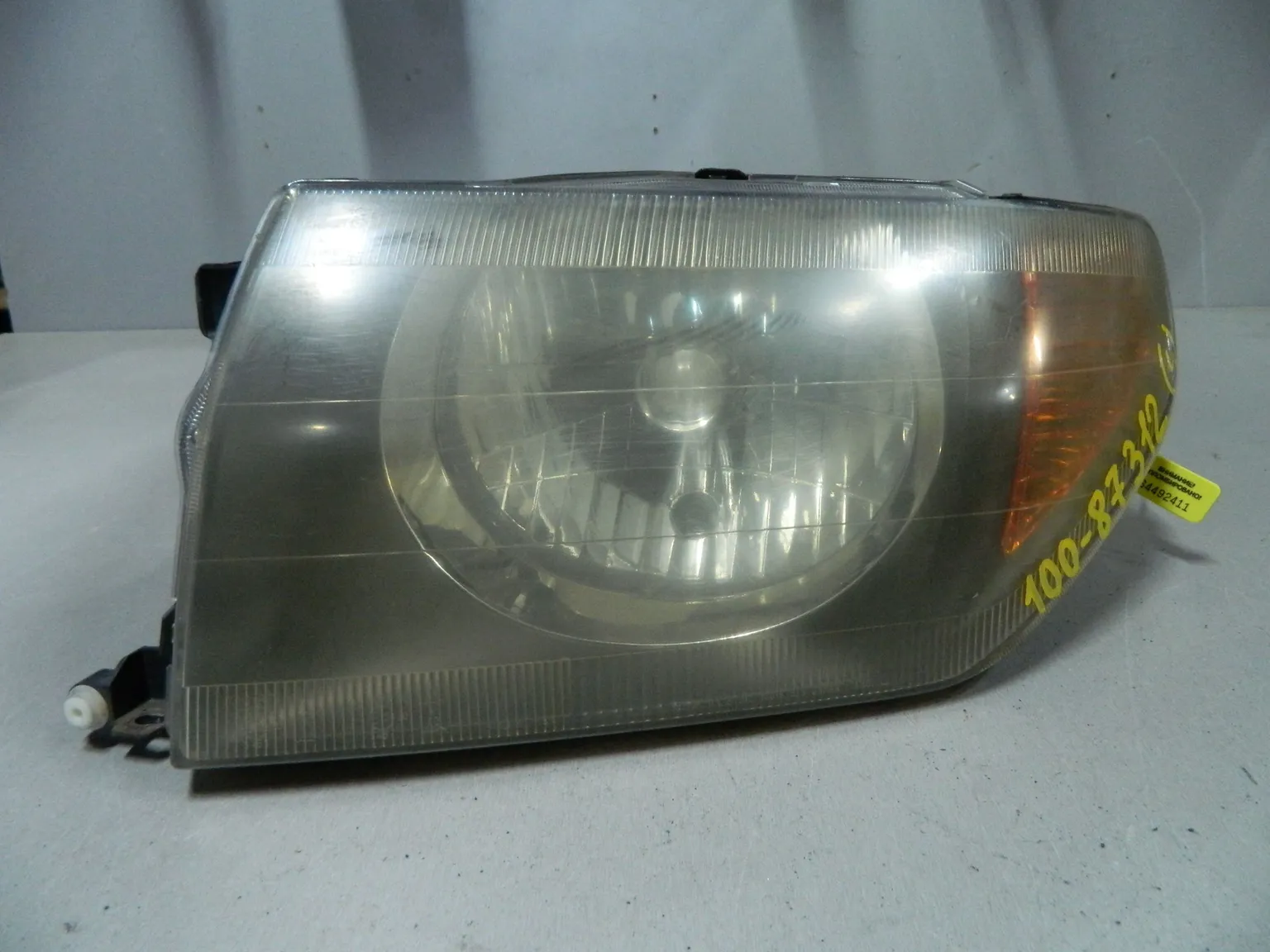 Фара MITSUBISHI PAJERO IO H76W Перед Лев (Контрактный) 64492411